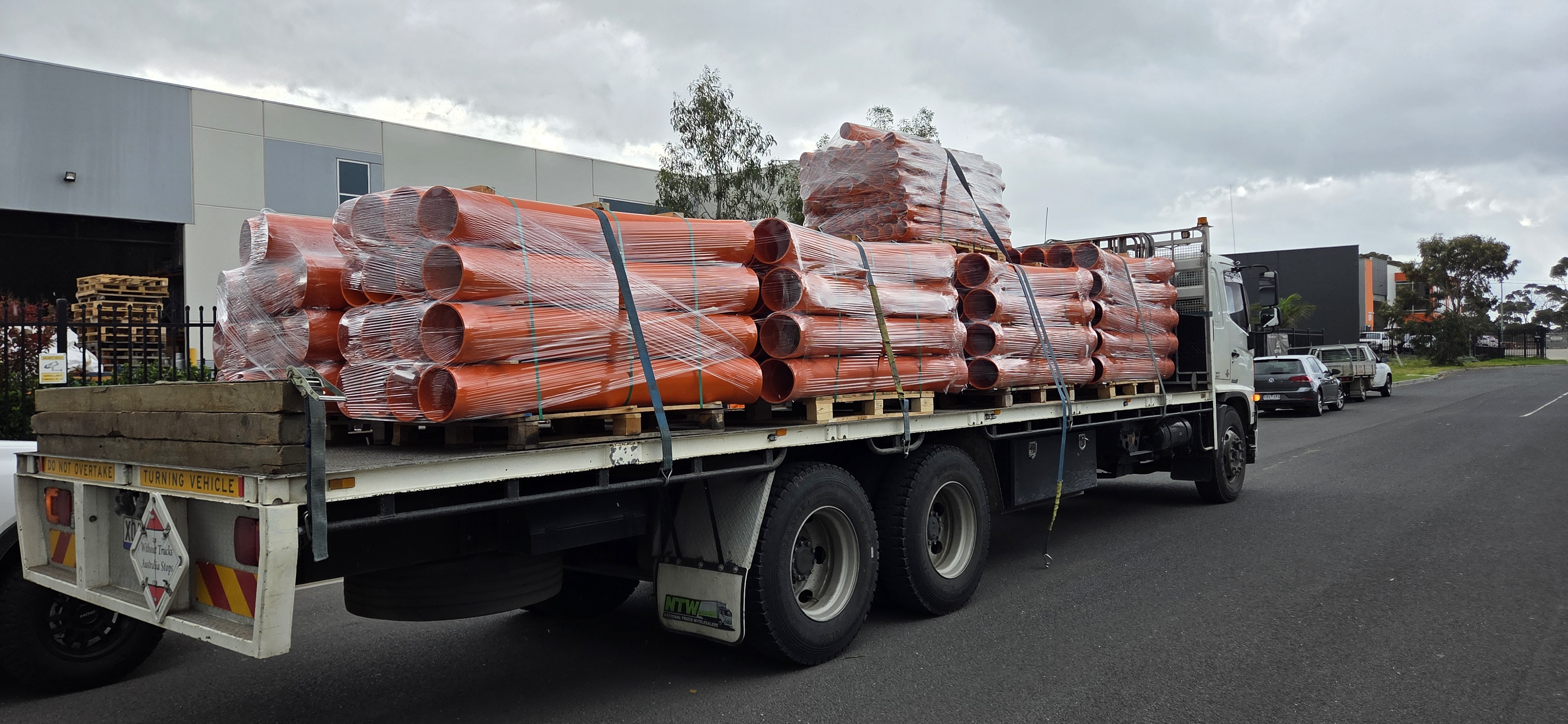 Orange conduit sweep bends in trench